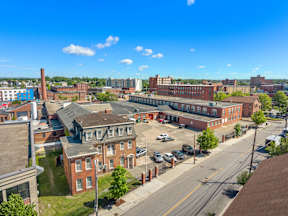 A view of a town with buildings and cars.