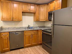 Essex Stoughton kitchen with granite countertops stainless appliances dishwasher range oven microwave