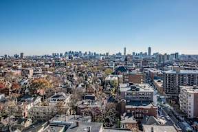 A cityscape with a mix of residential and commercial buildings.