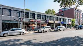 Commercial strip with Dunkin’ and local businesses in Central Square near 929 Mass Apartments in Cambridge MA