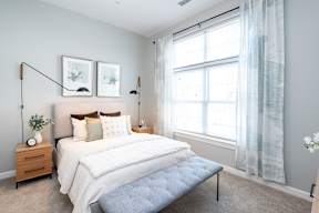 One Wall Street Bedroom Bed with large open windows and sunlight