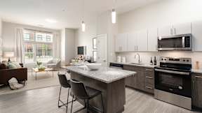 One bedroom den kitchen with granite counters, stainless appliances and large living room window