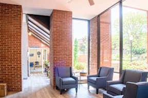 A room with a brick wall and a ceiling fan.