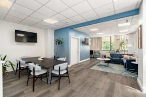 A conference room with a table and chairs.