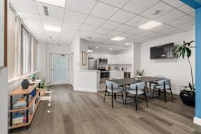 A modern kitchen with a dining table and chairs.