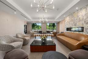 A modern living room with a stone wall and a large window.