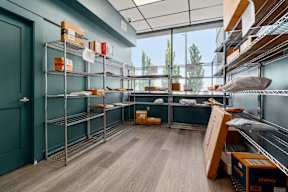 A room with shelves and boxes on the floor.