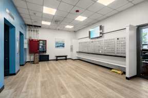 A room with a long bench and a wall of electrical outlets.