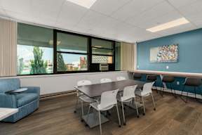 A conference room with a long table and chairs.