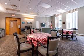 the community room with a table and chairs