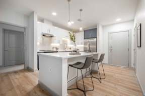 a kitchen with a white counter top next to a doorway