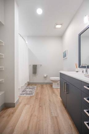a bathroom with a toilet a sink and a mirror