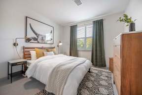 a bedroom with a bed and a dresser