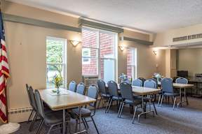 A conference room with a long table and chairs.