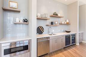 Community lounge kitchen with oven, dishwasher, sink, and refridgerator