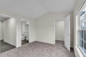 A room with a carpeted floor and white walls in the Loft at the Ledges Apartments.