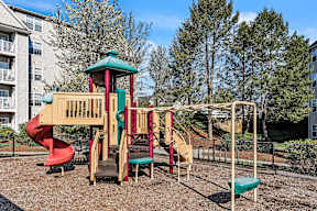 A playground with a red slide at the Ledges Apartments.