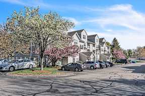 A parking lot with cars and apartments at the Ledges in Weymouth.