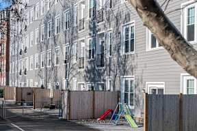 an empty playground in front of an apartment building