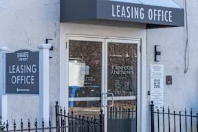 the outside of a leasing office with a gate