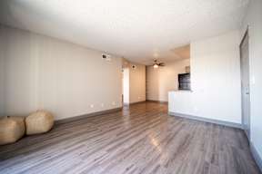 A room with wooden floors and a ceiling fan.