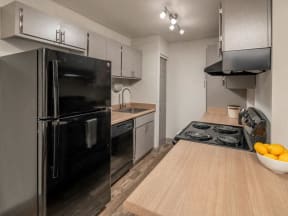 a kitchen with a stove top oven next to a refrigerator