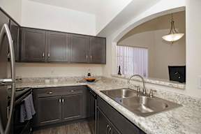 A kitchen with a sink and cabinets.