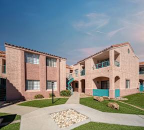 A pink building with a blue gate in front.