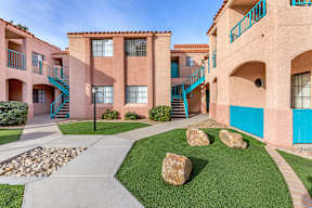 A building with a blue staircase and a green railing.