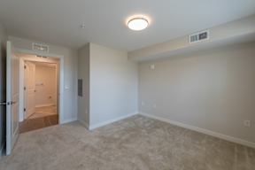 A room with a carpeted floor and a ceiling light.