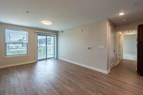 A room with wooden floors and a sliding glass door.