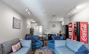 A living room with a Coca-Cola vending machine.