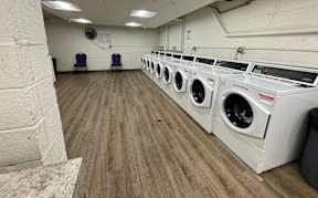 A laundromat with rows of washers and dryers.
