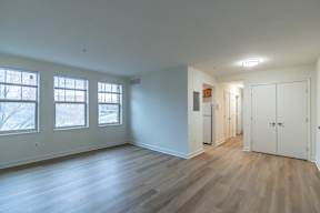 A room with wooden floors and white walls.