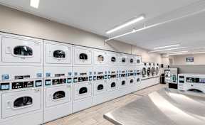 A row of washing machines in a laundromat.