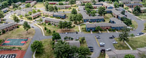 A bird's eye view of a residential area with a basketball court.