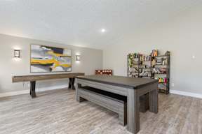 A room with a long table and a bench.