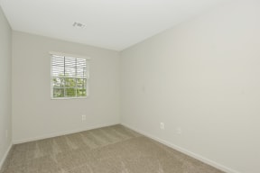a bedroom with white walls and a window  at Platt Gardens, West Babylon, 11704