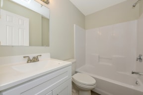 a bathroom with a sink toilet and bathtub  at Platt Gardens, West Babylon