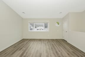 a bedroom with hardwood floors and a large window  at Platt Gardens, West Babylon, NY