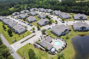 an aerial view of a subdivision with houses and a swimming pool