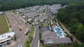 an aerial view of a subdivision with a swimming pool and parking lot