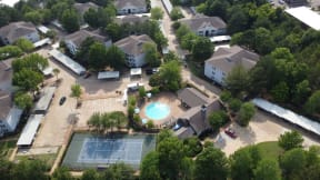 an aerial view of a house with a swimming pool and tennis court