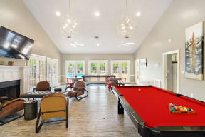 a recreation room with a pool table and a flat screen tv