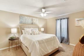 a bedroom with a bed and a ceiling fan