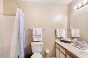 a bathroom with a toilet sink and shower