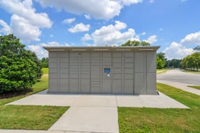 a metal storage shed on a grassy lawn at Audubon Park Apartment Homes, Louisiana, 70791