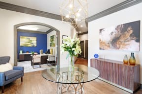 a dining room with a glass table and a blue chair