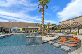 a swimming pool with a palm tree in the middle of it  at Reserve at Gulf Hills Apartment Homes, Mississippi