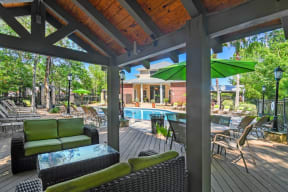 a patio with a pool and lounge chairs